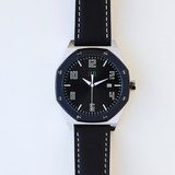 Front view of the LUQ Stainless Steel Watch with a bold 45mm stainless steel case, black dial, and genuine leather strap. Features a minimalistic design with luminous hands and numerals for easy readability.